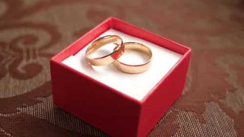 Golden Wedding Rings Close Up in Red Box