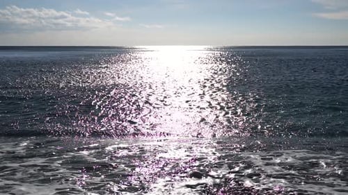 Abstract Shining Sun Reflections on Blue Surface of Sea Waves