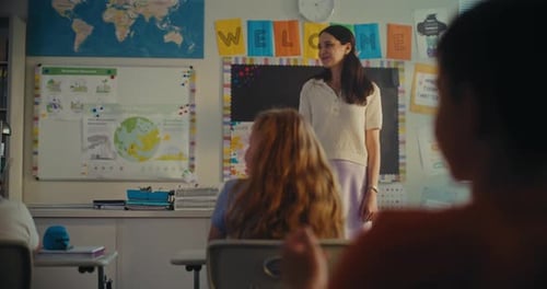Female Teacher Calling Young Student to the Board Primary School Girl Showcasing Knowledge of