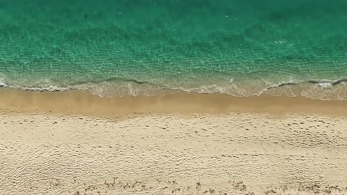 Aerial Above View of Empty Sandy Beach and Ocean with Waves