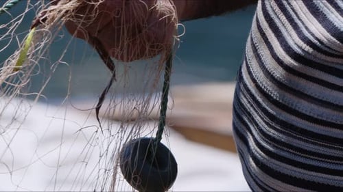 Fisherman Is Repairing Fishnets On Fishing Boat In Dock 10
