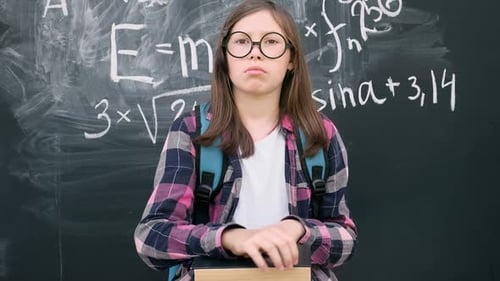 Girl Solving Math Problem at Chalkboard