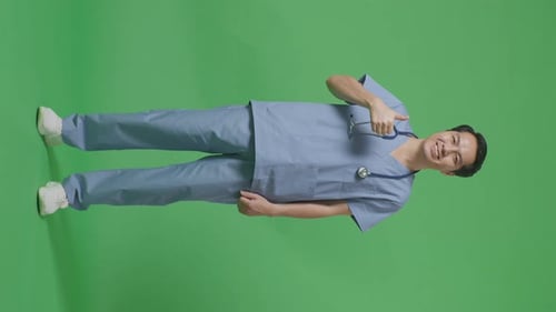 Full Body Of Asian Male Doctor With Stethoscope Showing Thumbs Up Gesture On Green Screen Background