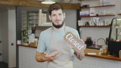 In a Cozy Cafe a Friendly Barista Welcomes Customers with an Open Sign Inviting Them to Enjoy