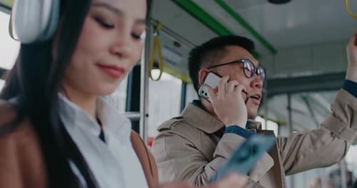 People Riding Bus Using Mobile Phones