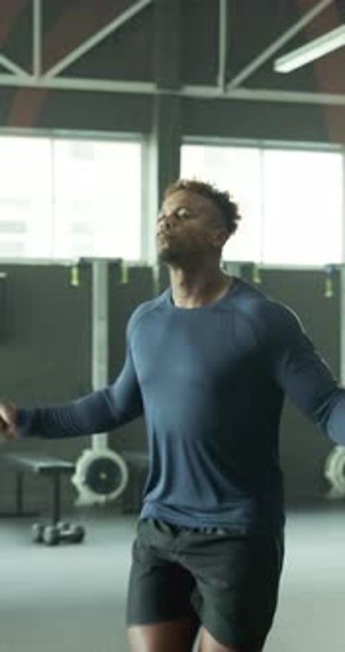 Man, training and skipping in gym for fitness, improve coordination or cardio exercise