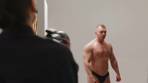 Male Bodybuilder Showing Muscles while Having Studio Portrait Photoshoot