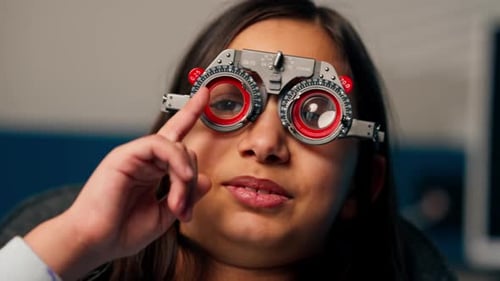 In an Ophthalmology Clinic Obese Doctor Tries on Provisional Glasses for a Girl to Choose Lenses