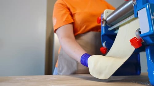 Unrecognizable Cook Using Dough Roller Rolling Out Dough for Pastry Indoors