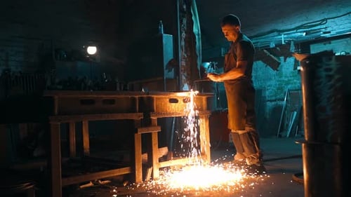 General View of a Worker Cutting Metal with an Oxyfuel Torch in a Workshop