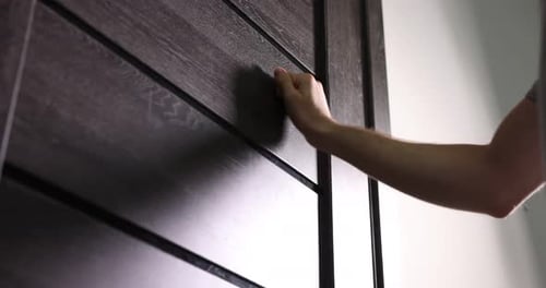 Man knocking on apartment door, low angle view