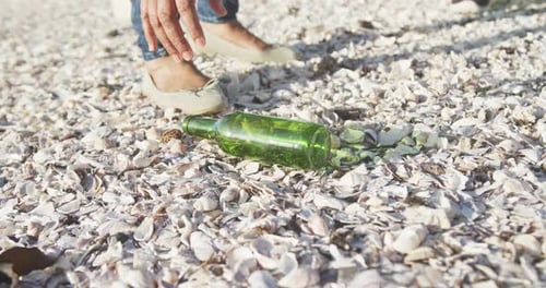 Low section of senior african american couple cleaning beach, slow motion