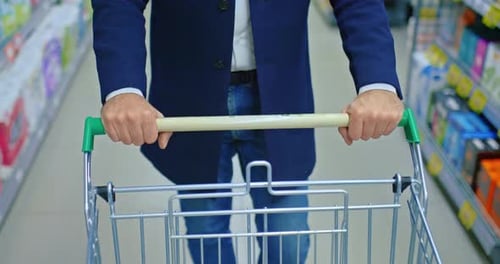 Man Shopping in Sales Season Hands on Shopping Cart in Aisle of Supermarket Closeup Prores