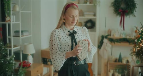 Joyful Woman Decorating Wrapping Christmas Gifts For Xmas Holidays