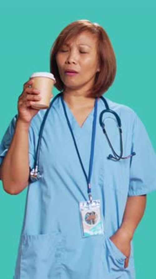 Healthcare Worker Drinks Coffee in Studio