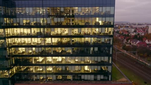 Cinematic Drone View of LateNight Office Work in Glass Skyscrapers