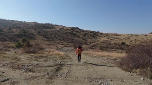Aerial View Young hiker walking on a mountain path on a sunny day