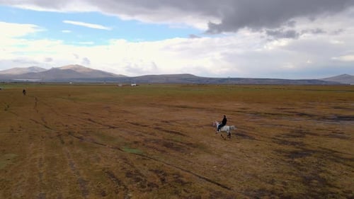 Horseback Riding in Wide Open Rural Landscape