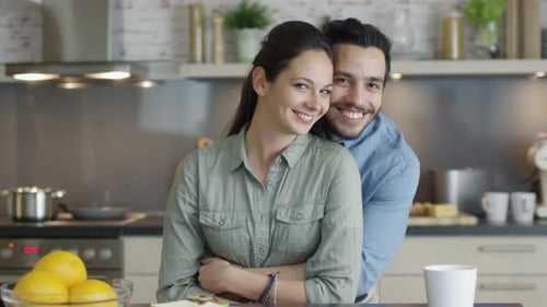 Happy Couple Embracing in Modern Kitchen Setting