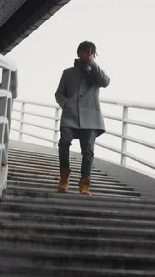 Walk in City in Autumn Black Man Going Down Over Stairs in Outskirts Vertical Portrait Urban