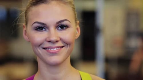 Smiling blonde woman portrait at the gym