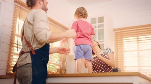 Happy Family Playing Together in Kitchen