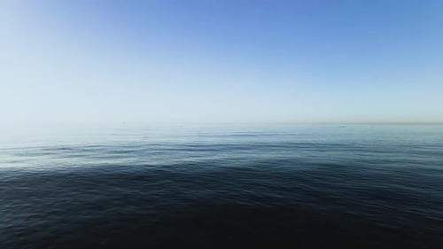 Static shot of the ocean during sunrise