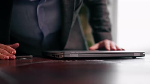 a serious businessman financier working on an important project at a laptop in the office