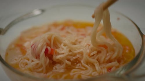 Noodle Eating Hand Mixing Quick Noodle Soup with Chopsticks Close Up Slow Motion