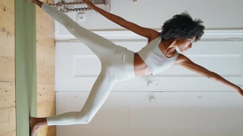 Flexible Woman Stretching Body in Cozy Place Athlete Practice Asana Vertically