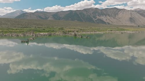 Klare, weißliche Skyline, die auf der stillen Wasseroberfläche reflektiert wird