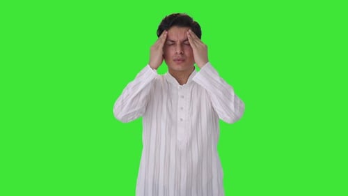 Sick Indian man suffering from headache Green screen