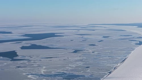 Majestic Frozen Sea Under a Bright Blue Sky Captures Tranquil Winter Vibes
