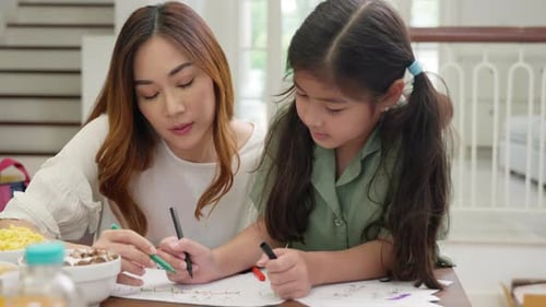 Mother and Daughter Drawing Together at Home