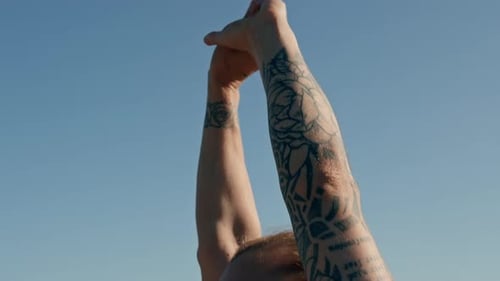 Fitness young sportswoman girl in the morning doing warm-up exercises before training on the street