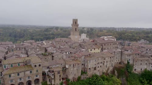 Aerial view of medieval village with cathedral on cliff, Italy.
