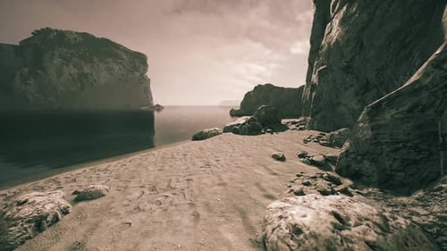 Serene Beach Landscape with Rocky Cliffs and Calm Waters at Twilight