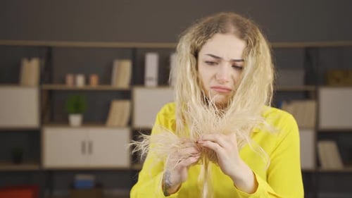 Sad woman with bad and unkempt hair.