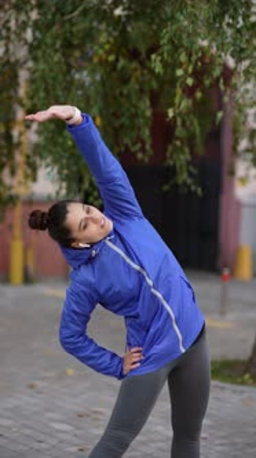 Woman Exercising and Stretching in Urban Setting