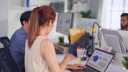 Young attractive businessman and businesswoman work in office workplace.