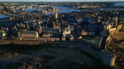 Forward drone movement towards the Intra Muros district at sunset, Saint-Malo, France.