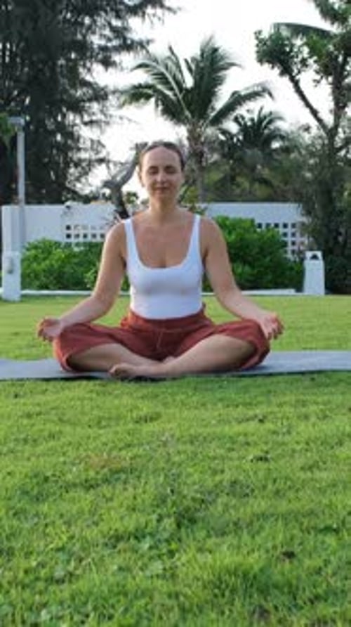 Woman Meditating While Doing Yoga Outdoors
