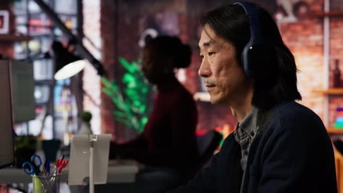 Startup Office Chief Technology Officer Listens Music While Coding Application