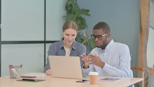 Young Business People Discussing Work in Office
