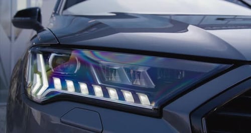 Close Up of Car Headlight in Urban Setting