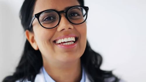 Happy young doctor smiling portrait in hospital healthcare slow motion