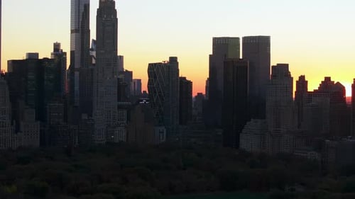 Sunset Casts a Warm Glow Over the Midtown Manhattan Skyline Viewed From Central Park The Scene