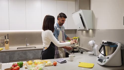Couple Cooking Together in Modern Kitchen at Home