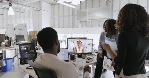 Business People Video Conferencing Meeting at Computer in Office Business
