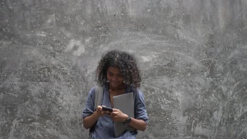 Young Black student woman is living in city.